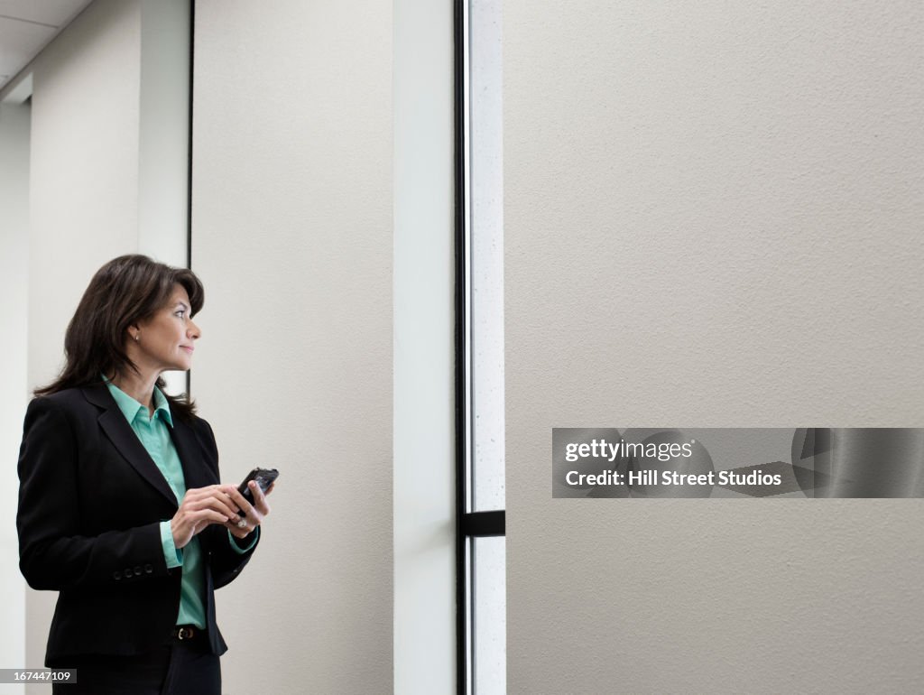 Caucasian businesswoman using cell phone