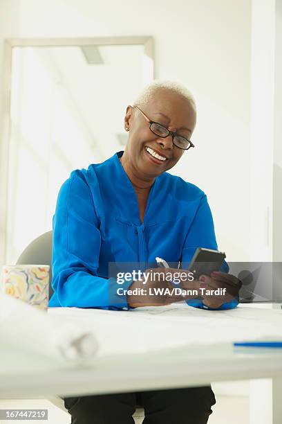black businesswoman using cell phone - elderly receiving paperwork stock pictures, royalty-free photos & images