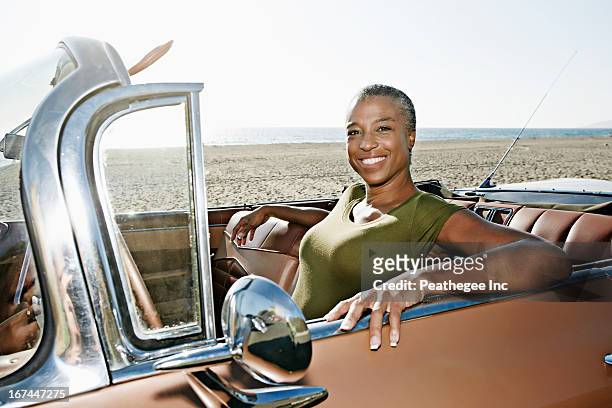 Black woman sitting in convertible