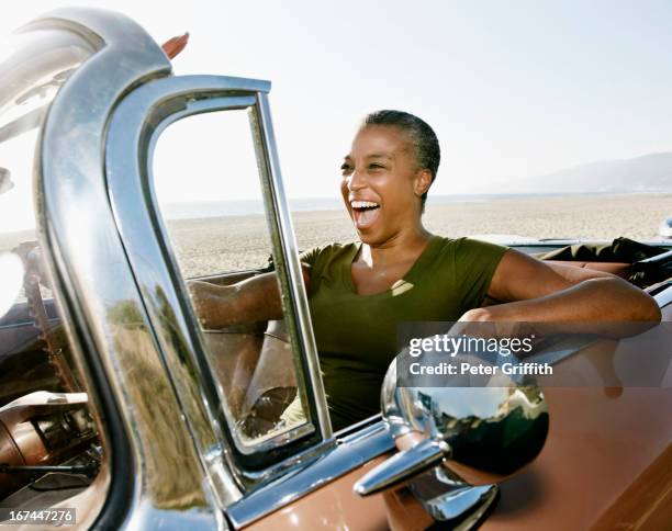 black woman driving convertible - convertible car stock pictures, royalty-free photos & images