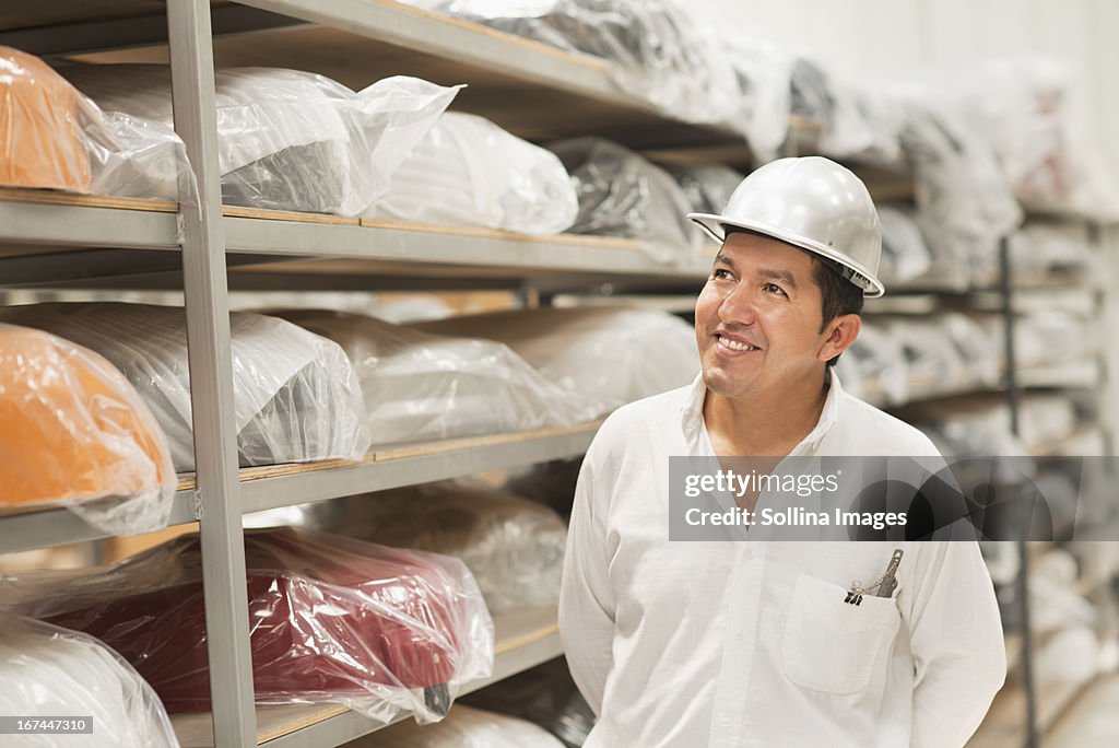 Worker smiling in manufacturing plant