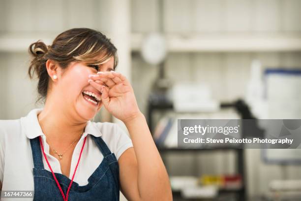 worker laughing in manufacturing plant - woman surprise stock pictures, royalty-free photos & images