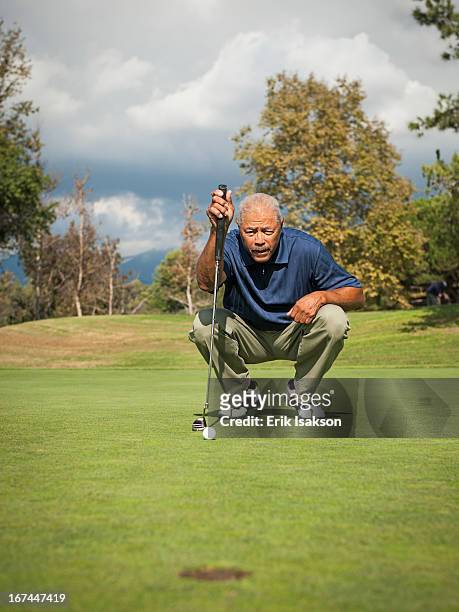 black man playing golf - golf putter stock pictures, royalty-free photos & images