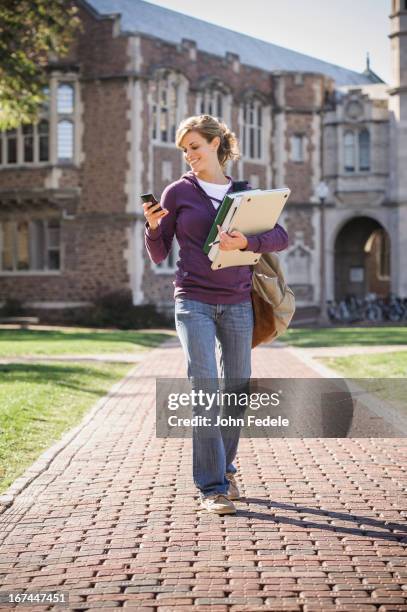 caucasian student walking on campus - university of missouri fotografías e imágenes de stock