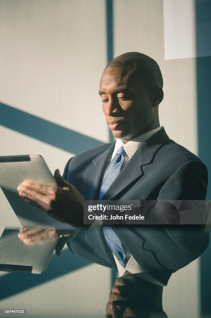 Black businessman using tablet computer