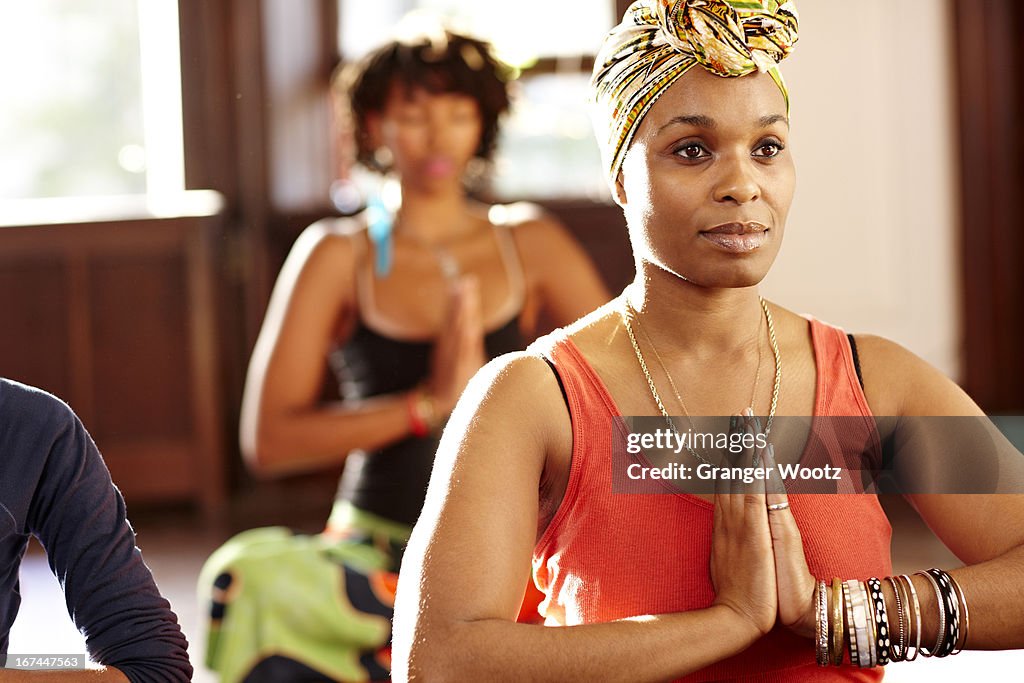 Woman meditating in yoga class