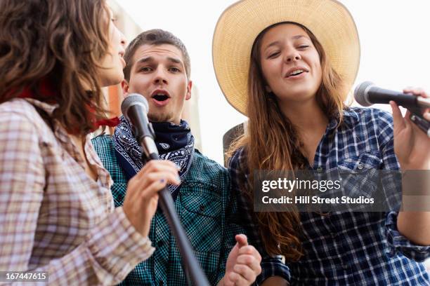 students singing together - country western outside stock-fotos und bilder