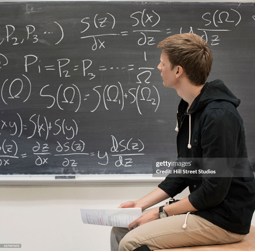 Caucasian student working from blackboard
