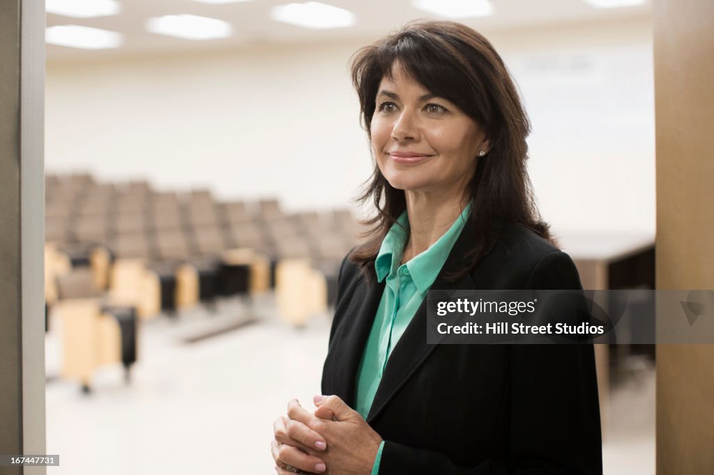 Caucasian teacher in empty classroom