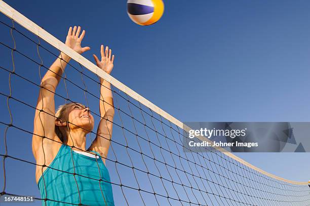 young woman playing beach volleyball - volleyball net stock pictures, royalty-free photos & images