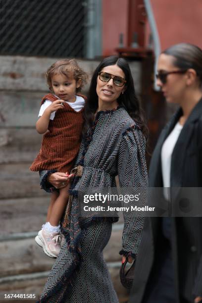 Ulla Johnson Fashion week guest Babba Rivera is seen wearing a frayed onepiecer consisting of a motif with many lines in blue, white and red, a brown...