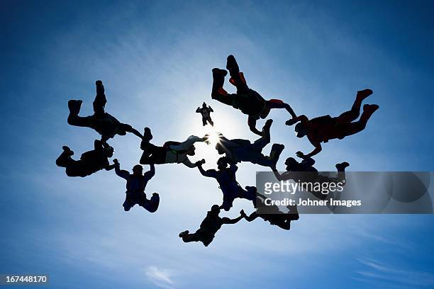 skydivers in mid-air - aerial stunts flying stock pictures, royalty-free photos & images