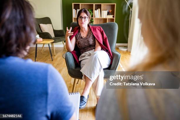 photo of female marriage counselor made above shoulders of mature spouses during consultation - terapia de pareja fotografías e imágenes de stock