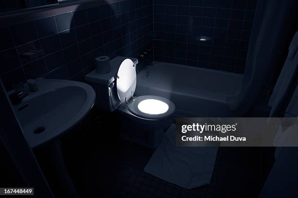 toilet glowing and emitting light in the bathroom - emitting stock pictures, royalty-free photos & images