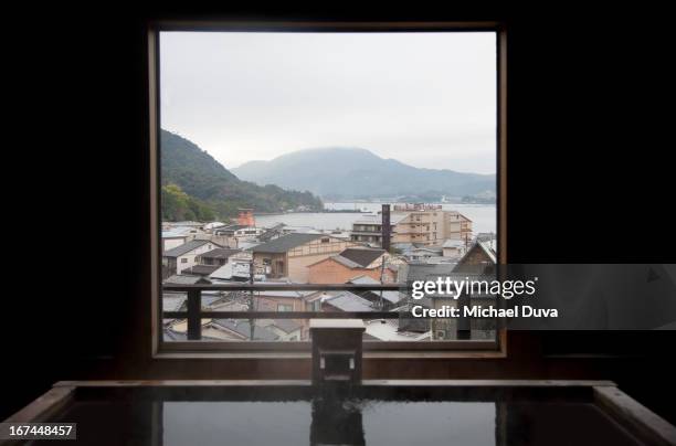 view of miyajima's gate from a bath house window - onsen japan stock pictures, royalty-free photos & images