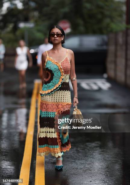 Ulla Johnson Fashion week guest Stephanie Hui is seen wearing a colorful knitted dress in brown, green, orange and beige, prada shades, shiny green...