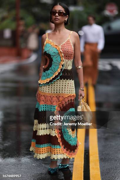 Ulla Johnson Fashion week guest Stephanie Hui is seen wearing a colorful knitted dress in brown, green, orange and beige, prada shades, shiny green...