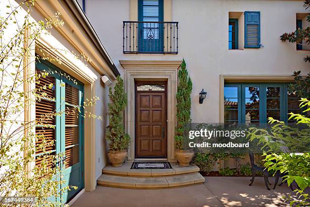 entrance to a beautiful mediterranean home exterior - doormat stock pictures, royalty-free photos & images