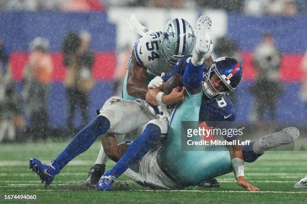 Micah Parsons of the Dallas Cowboys tackles Daniel Jones of the New York Giants at MetLife Stadium on September 10, 2023 in East Rutherford, New...