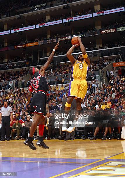 Kobe Bryant of the Los Angeles Lakers shoots over Eddie Robinson of the Chicago Bulls during the NBA game at Staples Center on November 22, 2002 in...