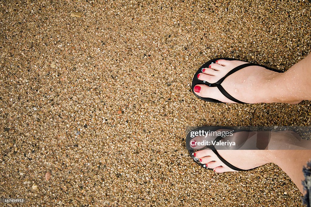 Beine auf Sandstrand