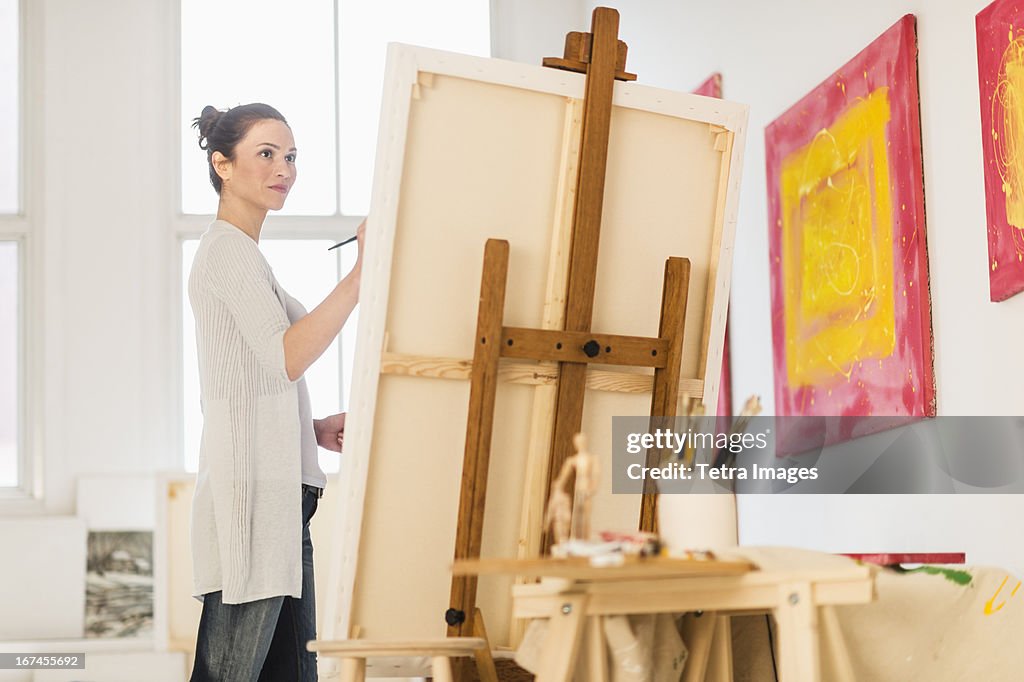 USA, New Jersey, Jersey City, Woman painting at easel