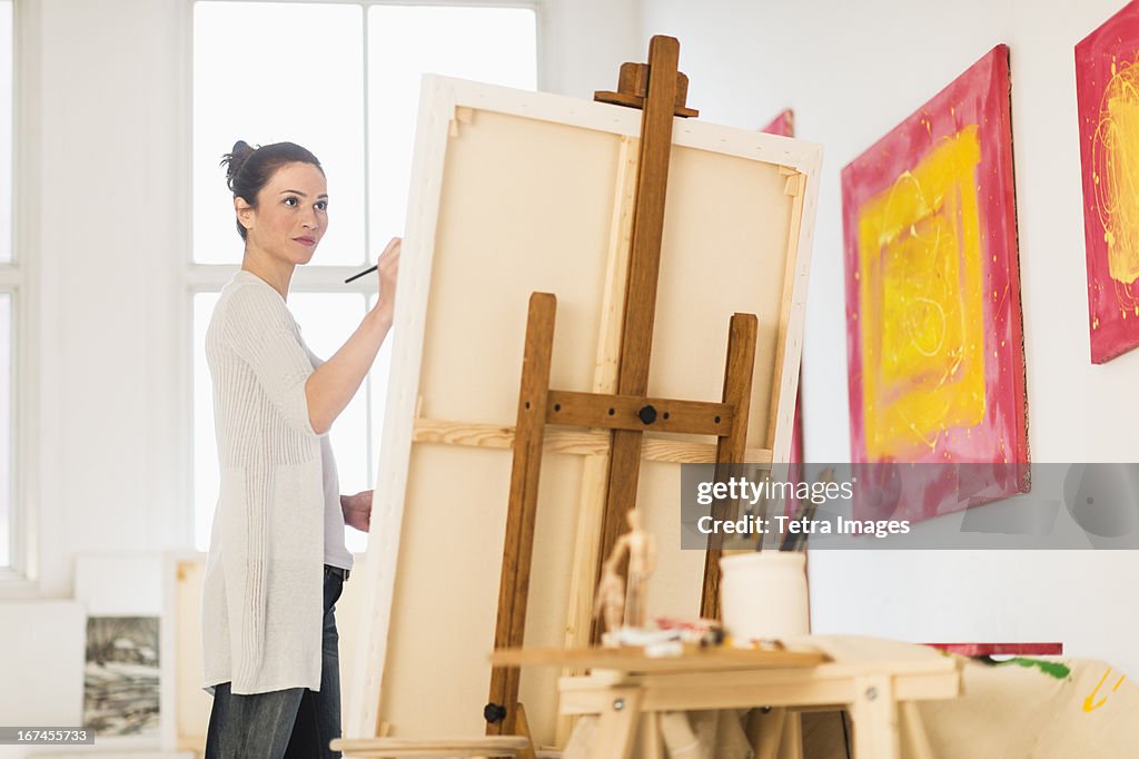 USA, New Jersey, Jersey City, Woman painting at easel