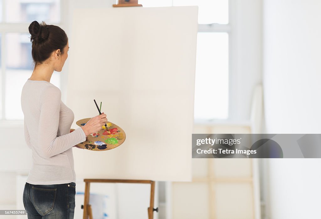 USA, New Jersey, Jersey City, Woman painting at easel