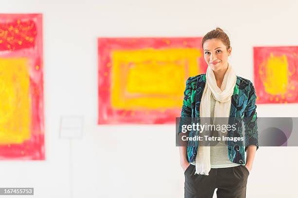 usa, new jersey, jersey city, portrait of woman with paintings in museum - art gallery owner stock pictures, royalty-free photos & images