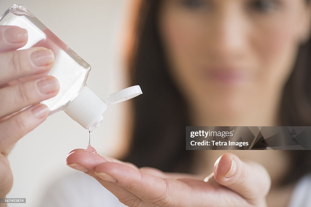 Woman using hand sanitizer