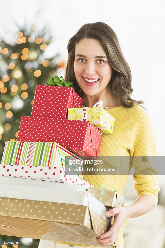 USA, New Jersey, Jersey City, Woman holding christmas gifts