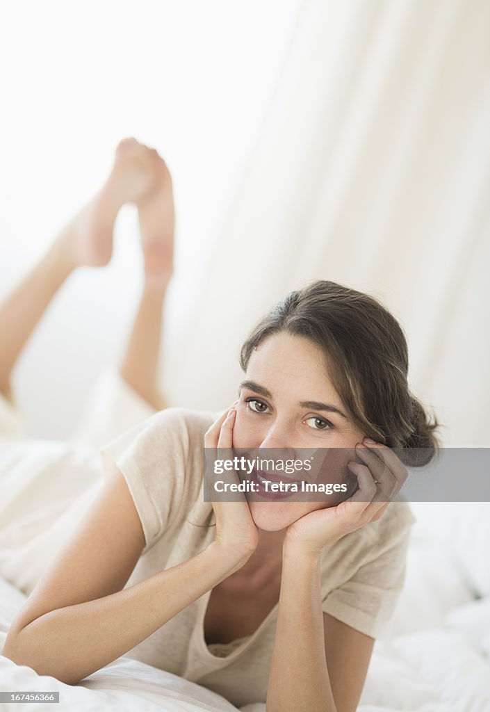 USA, New Jersey, Jersey City, Woman lying in bed 