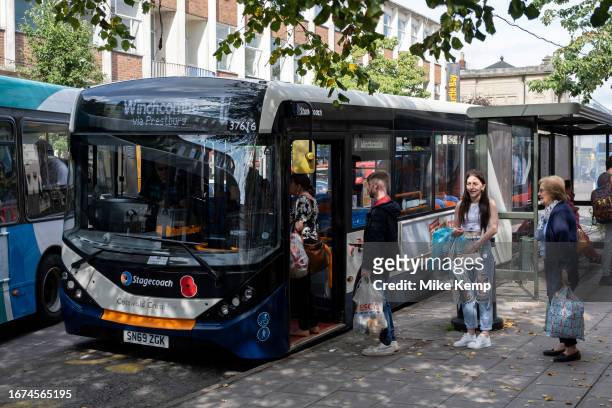 People queuing up to get on a local public transport bus service on 15th September 2023 in Cheltenham, United Kingdom. Cheltenham also known as...