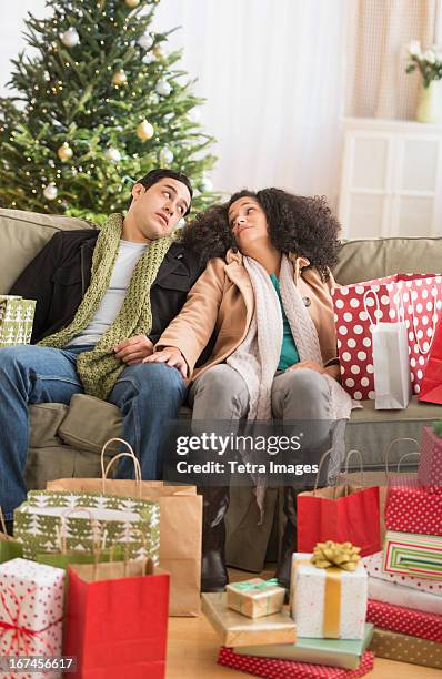 usa, new jersey, jersey city, couple with christmas presents in living room - ruined christmas stock pictures, royalty-free photos & images