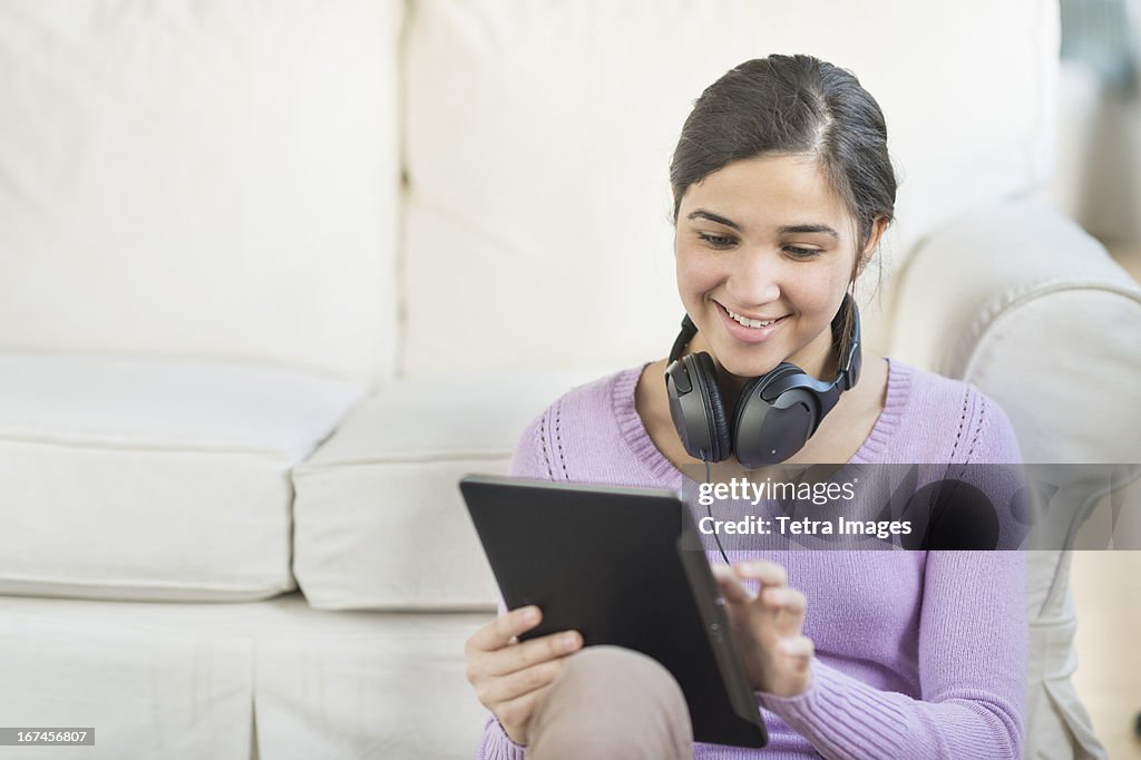 USA, New Jersey, Jersey City, Portrait of teenage girl (16-17) with digital tablet and headphones