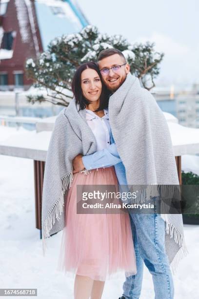 happy couple under blanket on a snowy day - under skirt stock pictures, royalty-free photos & images