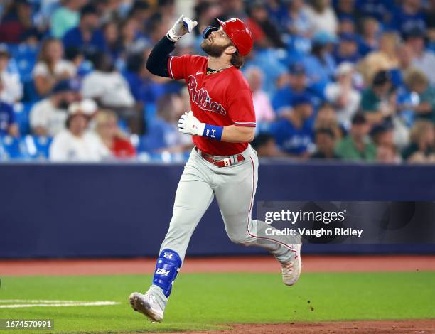 Bryce Harper of the Philadelphia Phillies runs the bases after hitting a home run in the ninth inning against the Toronto Blue Jays at Rogers Centre...