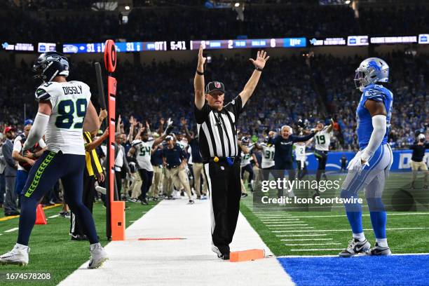 The referee signals touchdown as the Seattle Seahawks and Head Coach Pete Carroll celebrate their 37-31 overtime victory over the Detroit Lions on...