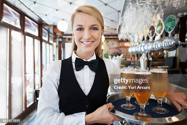 denmark, aarhus, portrait of young woman holding tray with beer glasses - bow tie stock pictures, royalty-free photos & images