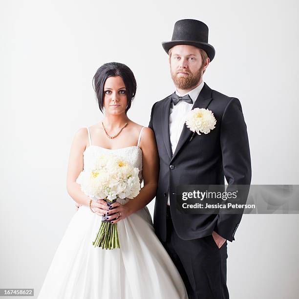 studio shot portrait of bride and groom - シルクハット ストックフォトと画像