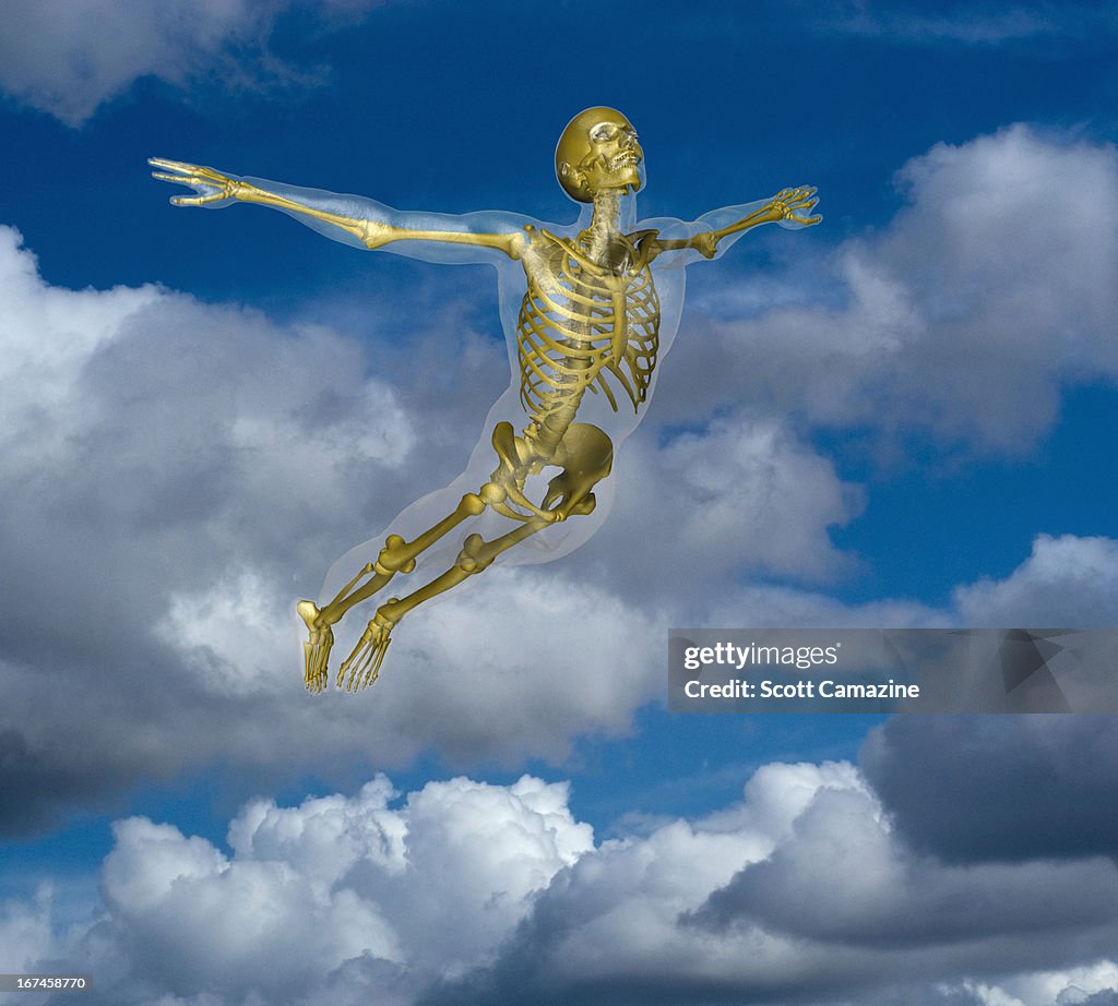 Human skeleton flying amidst clouds