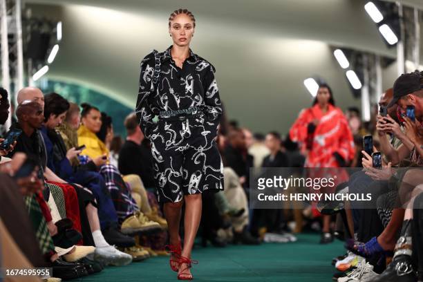 British model Adwoa Aboah presents a creation during a catwalk presentation for British fashion house Burberry's Spring/Summer 2024 collection, at...