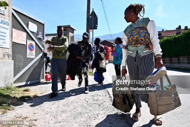 Migrants from Sudan and Guinea prepare to leave outside the Rifugio Fraternità Massi as they head to the bus station to go towards Claviere on...