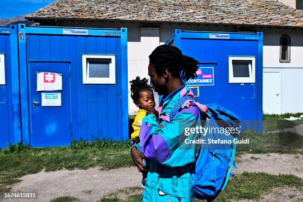 Sudan migrant and his few-month-old daughter prepare to leave inside the Rifugio Fraternità Massi on September 11, 2023 in Oulx, Italy. The Rifugio...