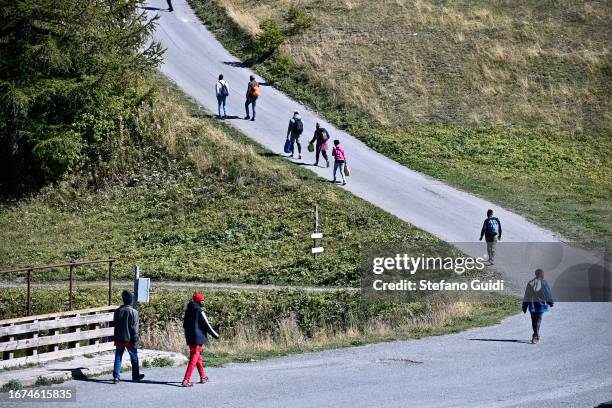 Sudan migrants walk on the road that leads to the entrance to the mountain trails that go to Briancon on September 11, 2023 in Claviere, Italy. For...