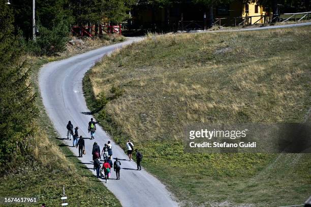 Sudan migrants walk on the road that leads to the entrance to the mountain trails that go to Briancon on September 11, 2023 in Claviere, Italy. For...