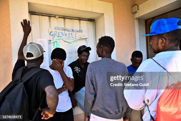 Migrants talk to each other on September 11, 2023 in Briancon, France. A tent city that was created after the closure of an overpopulation facility...