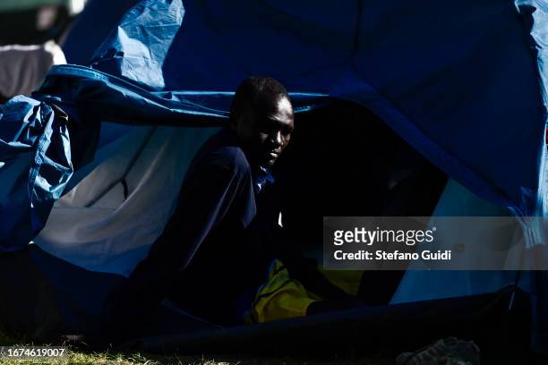Migrants waits inside a tent inside tent city managed by the Refuges Solidaires association on September 11, 2023 in Briancon, France. A tent city...
