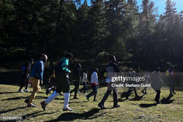 Large group of migrants walk along the mountain paths that go to Briancon on September 11, 2023 in Claviere, Italy. For about a month the situation...