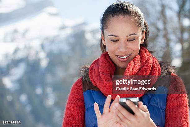 smiling woman checking cell phone - samuser stock pictures, royalty-free photos & images